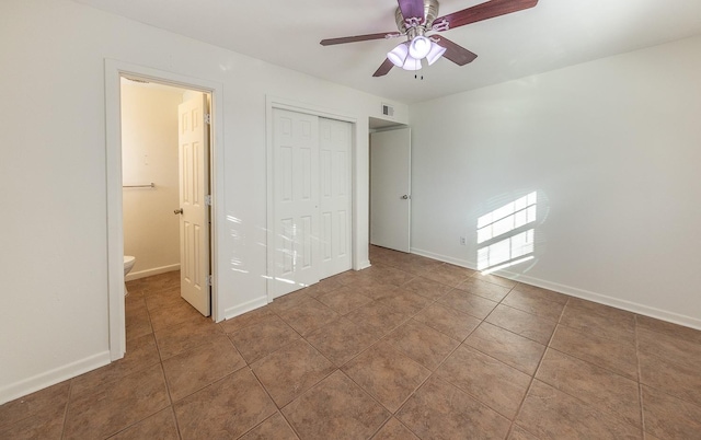 unfurnished bedroom with tile patterned floors, a closet, and ceiling fan