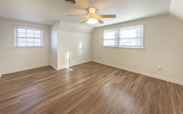 additional living space featuring vaulted ceiling, dark wood-type flooring, and ceiling fan