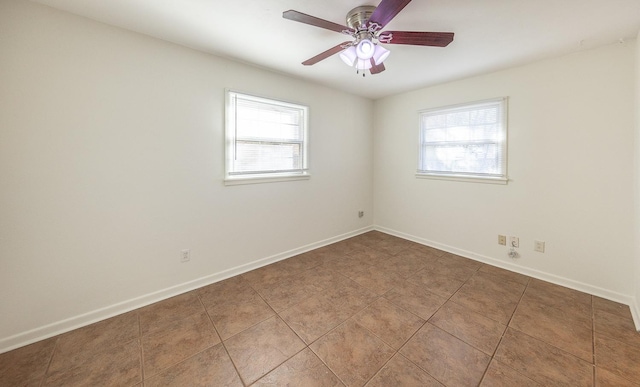 tiled spare room featuring ceiling fan