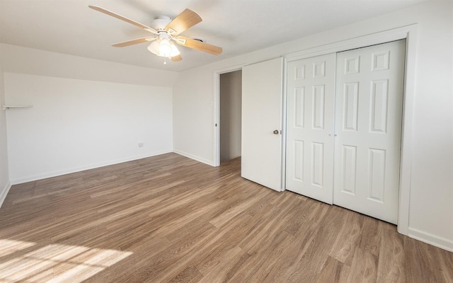 unfurnished bedroom with ceiling fan and hardwood / wood-style floors