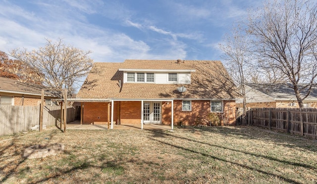 rear view of house featuring a patio and a lawn