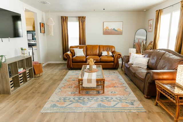 living room featuring light hardwood / wood-style floors and a wealth of natural light