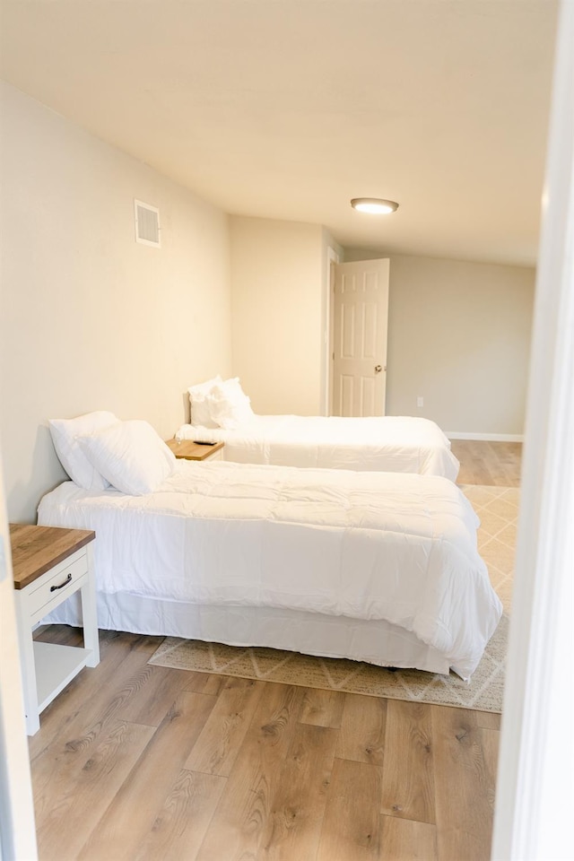 bedroom with wood-type flooring