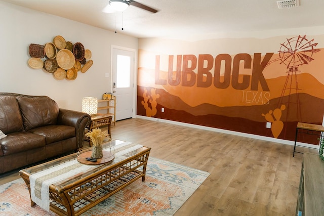 living room with wood-type flooring and ceiling fan