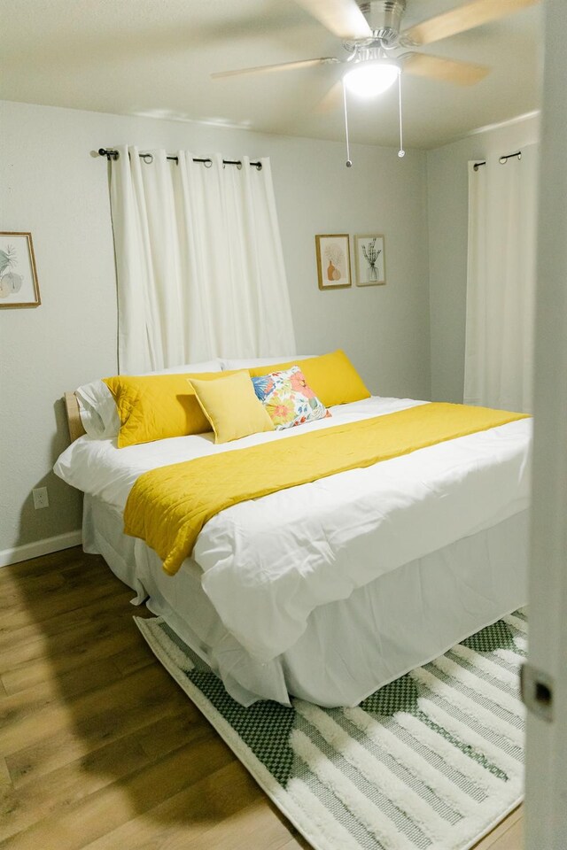 bedroom with hardwood / wood-style flooring and ceiling fan