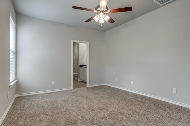 empty room featuring light colored carpet and ceiling fan