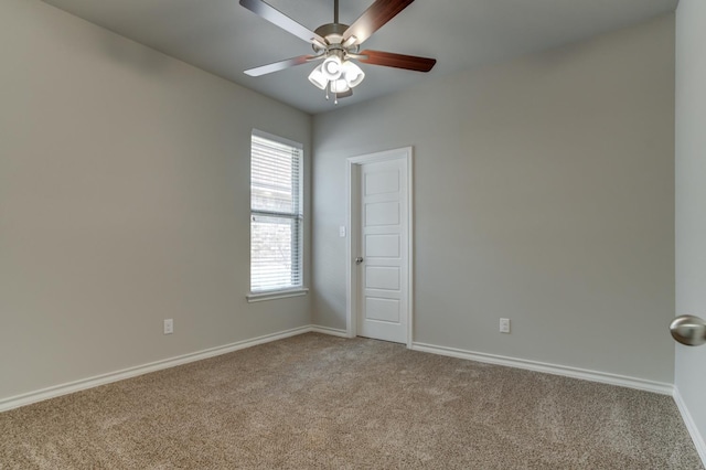 carpeted spare room with ceiling fan