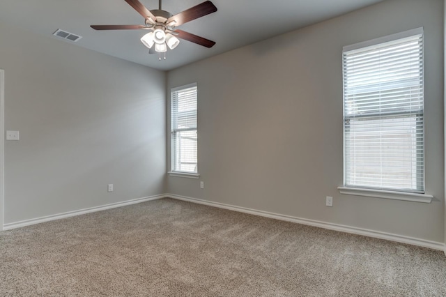 carpeted empty room featuring ceiling fan