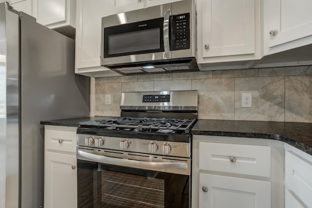 kitchen with appliances with stainless steel finishes, white cabinets, and decorative backsplash