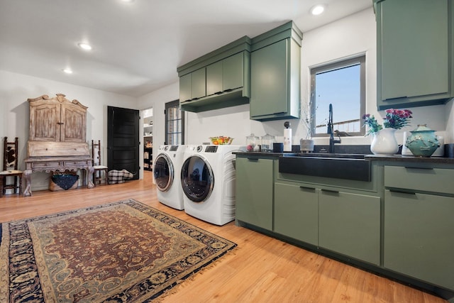4721 121st St, Lubbock, TX 79424 - washroom featuring washing machine and dryer, cabinet space, light wood finished floors, and recessed lighting