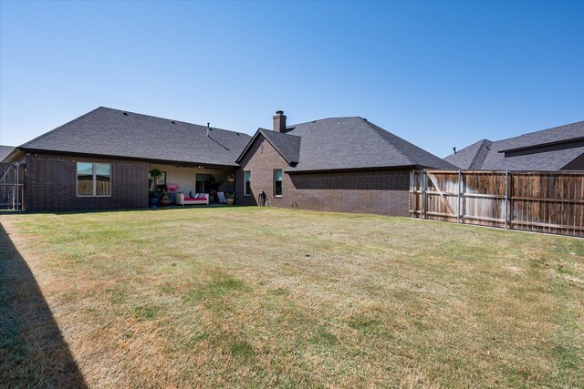 4721 121st St, Lubbock, TX 79424 - back of property featuring brick siding, a chimney, and roof with shingles