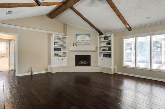 unfurnished living room with dark wood-type flooring, a fireplace, a textured ceiling, and vaulted ceiling with beams