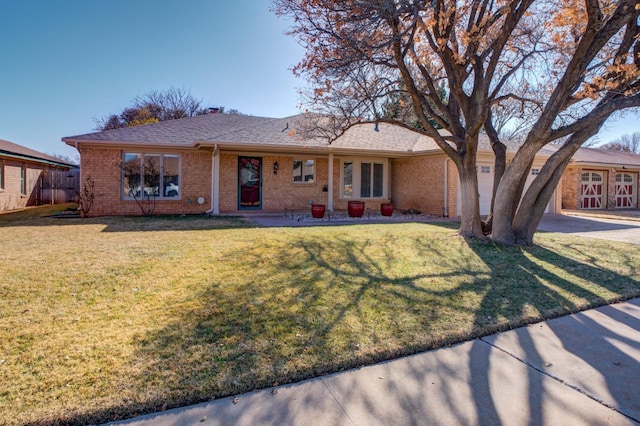 single story home featuring a garage and a front lawn