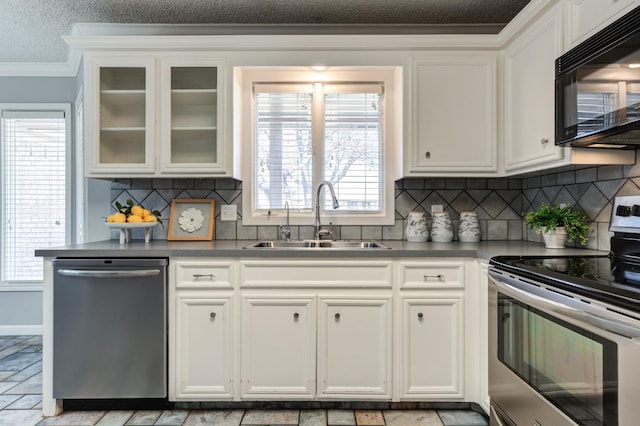 kitchen with sink, crown molding, appliances with stainless steel finishes, plenty of natural light, and white cabinets