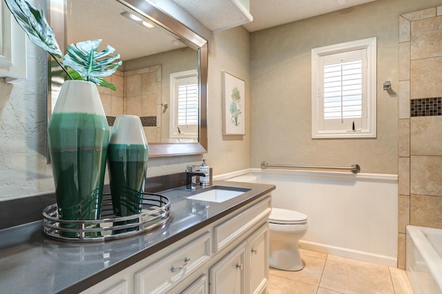 bathroom with vanity, tile patterned floors, and toilet