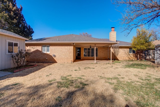 back of property featuring a patio and a yard