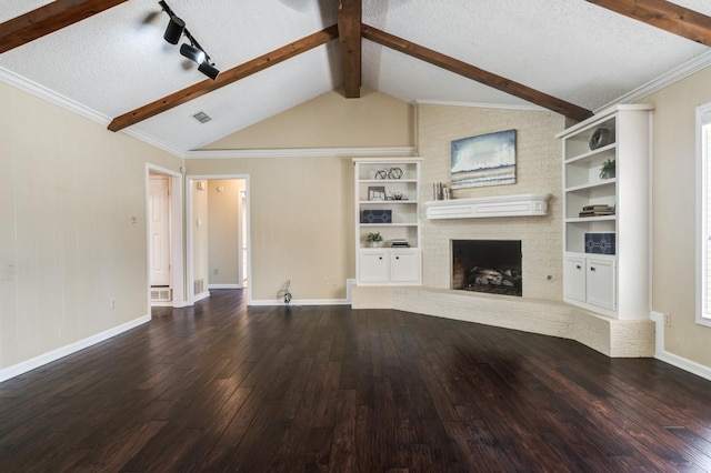 unfurnished living room featuring vaulted ceiling with beams, a fireplace, dark hardwood / wood-style floors, and a textured ceiling