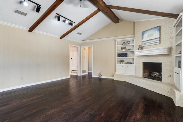 unfurnished living room featuring built in features, lofted ceiling with beams, wood-type flooring, crown molding, and a brick fireplace