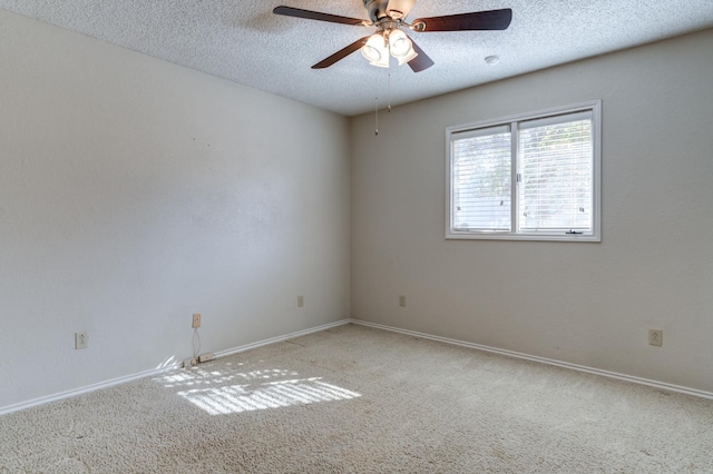 carpeted spare room featuring ceiling fan and a textured ceiling