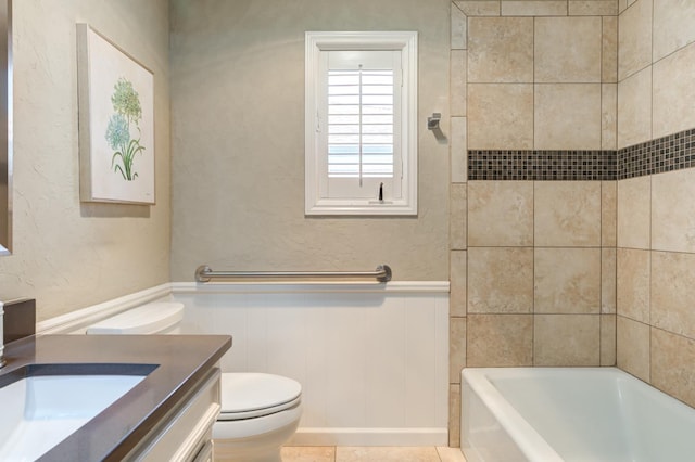 bathroom featuring vanity, tile patterned floors, and toilet