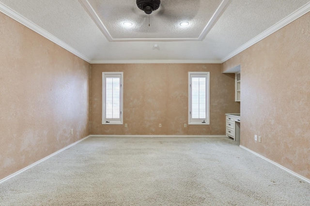 unfurnished room featuring crown molding, light colored carpet, and a textured ceiling