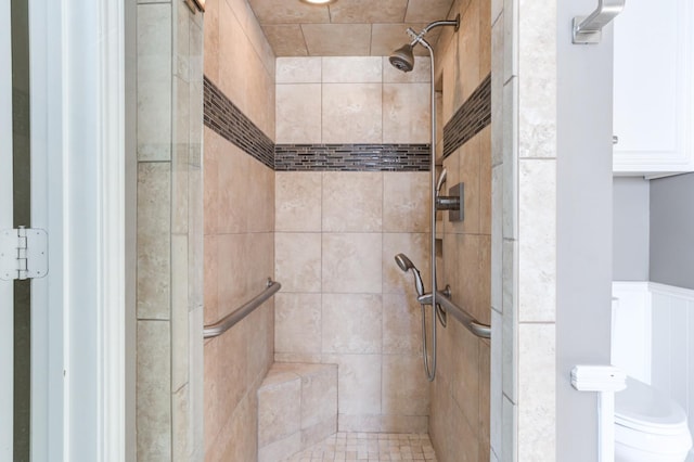 bathroom featuring toilet and tiled shower