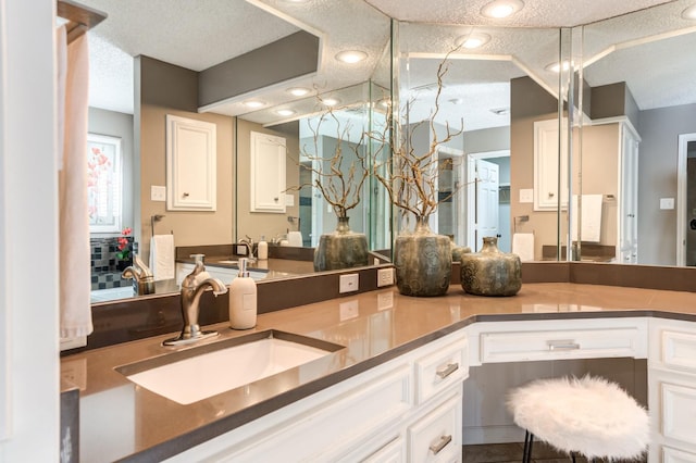 bathroom featuring vanity and a textured ceiling