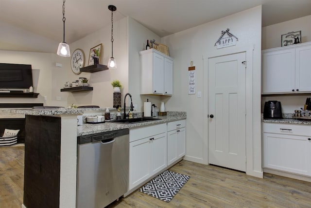 kitchen with open shelves, stainless steel dishwasher, a sink, light wood-type flooring, and a peninsula