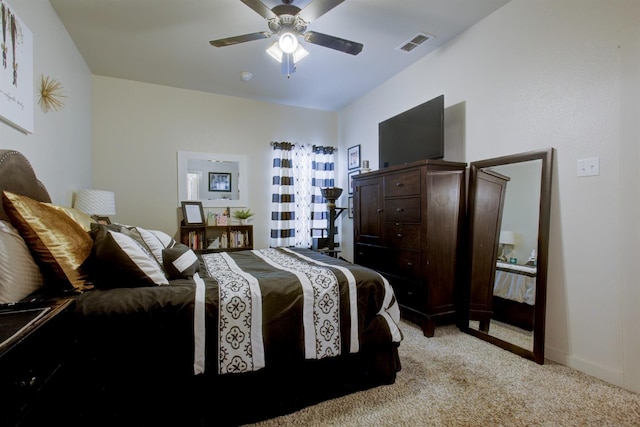 bedroom with light carpet, baseboards, visible vents, and a ceiling fan