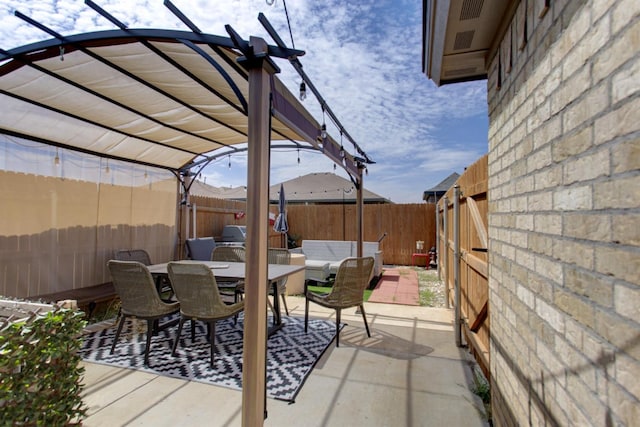 view of patio with outdoor dining area, a fenced backyard, and a pergola