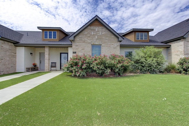 craftsman-style house with a front yard and brick siding