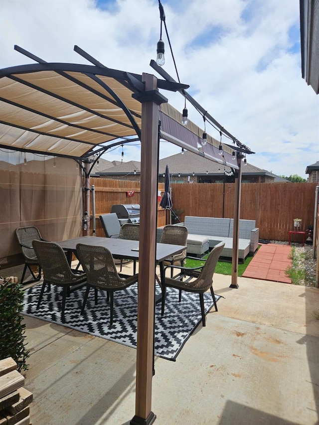 view of patio featuring fence, outdoor dining area, and a pergola