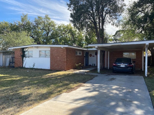 ranch-style house with a carport and a front lawn