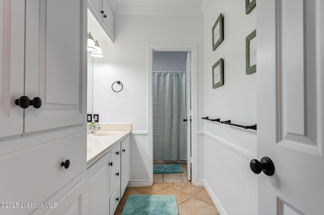 4510 21st St, Lubbock, TX 79407 - full bath with crown molding, double vanity, tile patterned flooring, a wainscoted wall, and a shower with shower curtain