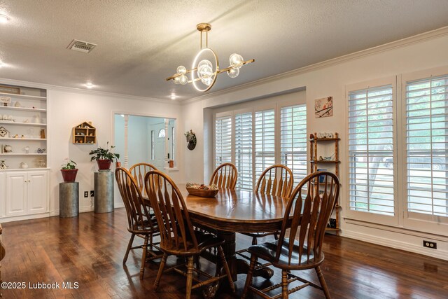 4510 21st St, Lubbock, TX 79407 - dining area featuring a textured ceiling, crown molding, a chandelier, and dark wood finished floors