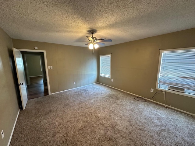 carpeted spare room with ceiling fan and a textured ceiling