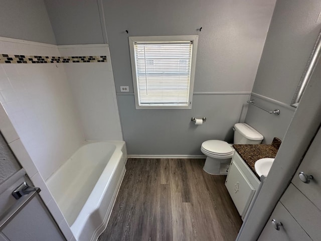 bathroom featuring vanity, toilet, and hardwood / wood-style floors