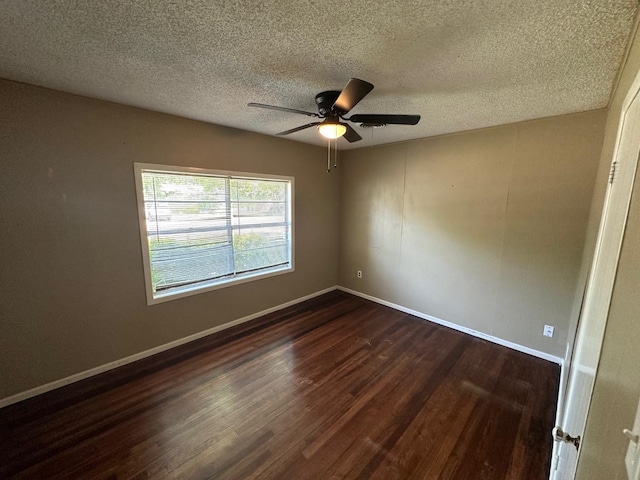 empty room with dark hardwood / wood-style flooring, ceiling fan, and a textured ceiling