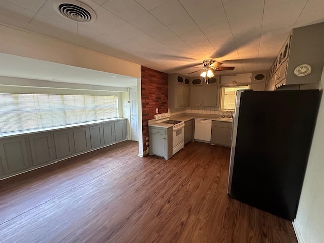 kitchen with ceiling fan, white appliances, dark hardwood / wood-style flooring, and sink