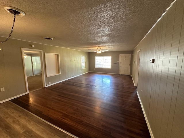 unfurnished room featuring dark hardwood / wood-style floors, a textured ceiling, and ceiling fan