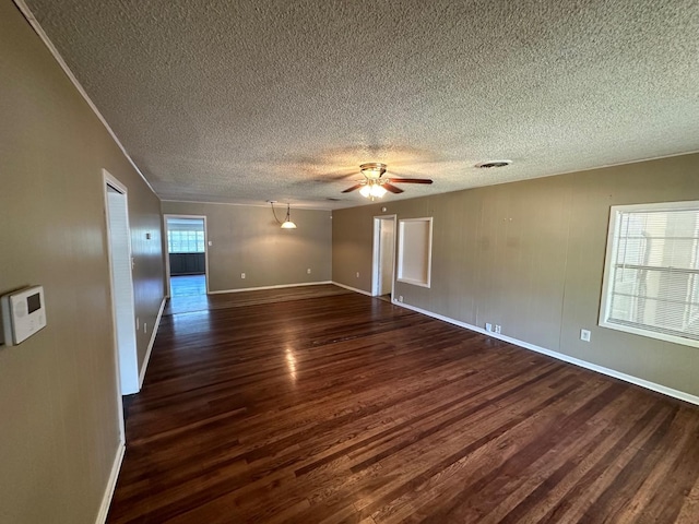 spare room featuring ceiling fan, a textured ceiling, and dark hardwood / wood-style flooring