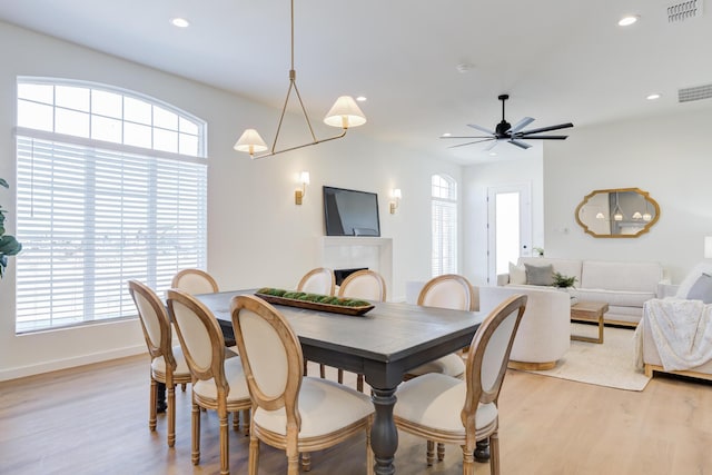 dining room with ceiling fan and light wood-type flooring