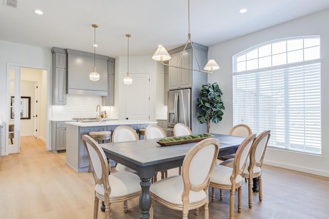 dining room featuring sink and light wood-type flooring