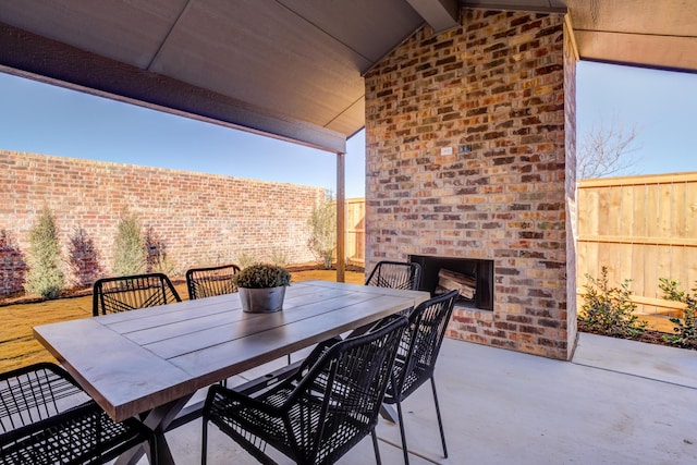 view of patio / terrace featuring an outdoor brick fireplace