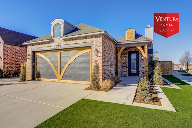 view of front of property with a garage and a front lawn