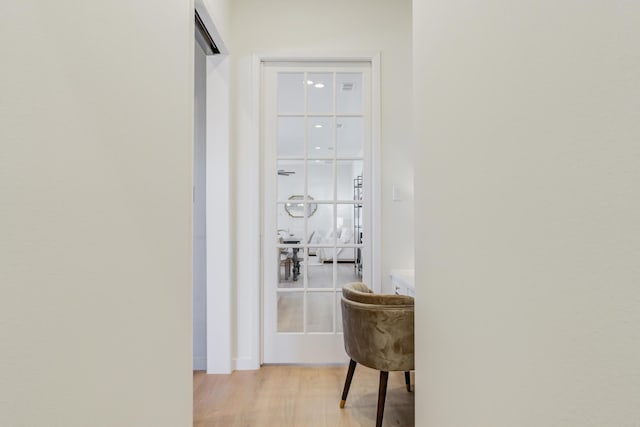 hallway with light hardwood / wood-style floors