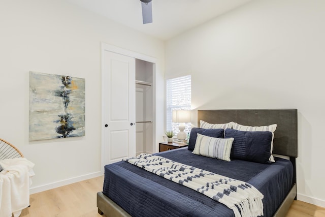 bedroom with wood-type flooring, ceiling fan, and a closet