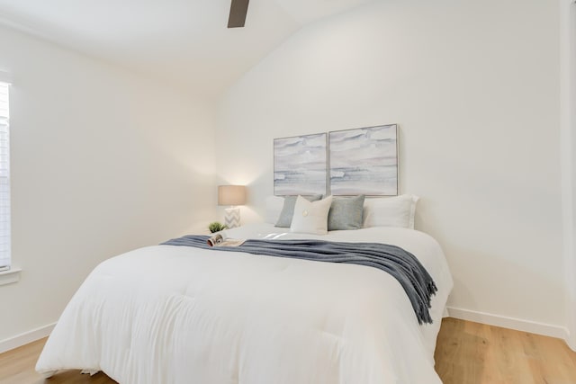 bedroom with lofted ceiling, hardwood / wood-style floors, and ceiling fan