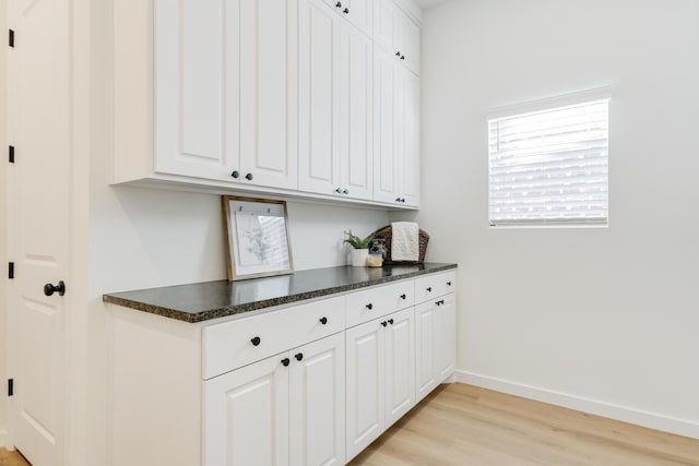 kitchen featuring white cabinetry and light hardwood / wood-style flooring