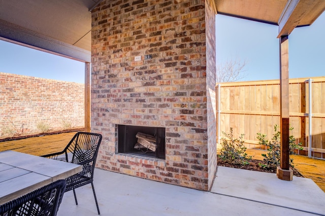 view of patio / terrace featuring an outdoor brick fireplace